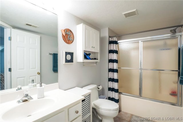 bathroom featuring visible vents, shower / bath combination with glass door, vanity, and toilet