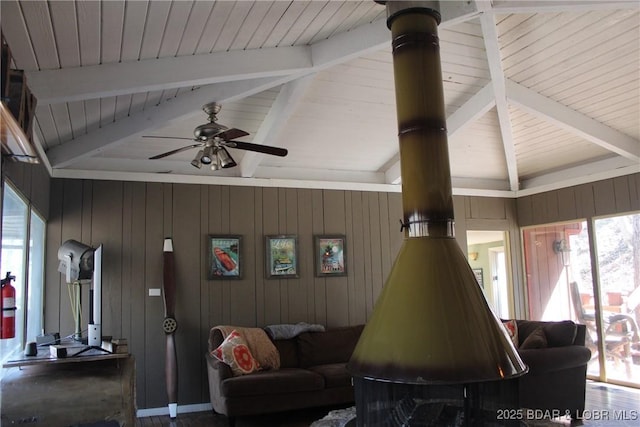 living room with vaulted ceiling with beams, a healthy amount of sunlight, and ceiling fan