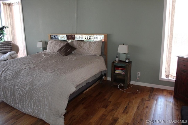 bedroom with baseboards and wood finished floors