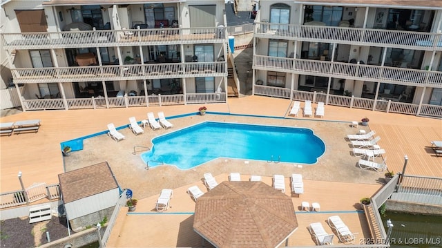 community pool featuring a patio area and fence