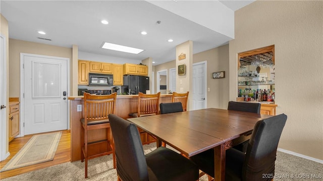 dining room featuring light wood-type flooring, visible vents, and recessed lighting