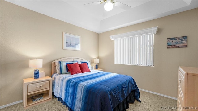 carpeted bedroom featuring ceiling fan and baseboards