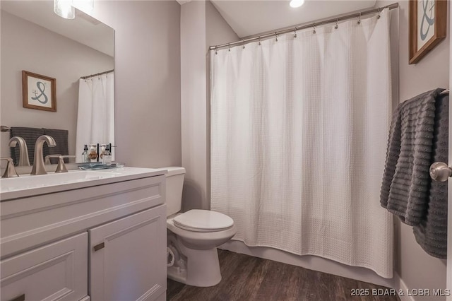 full bathroom with toilet, a shower with shower curtain, wood finished floors, and vanity