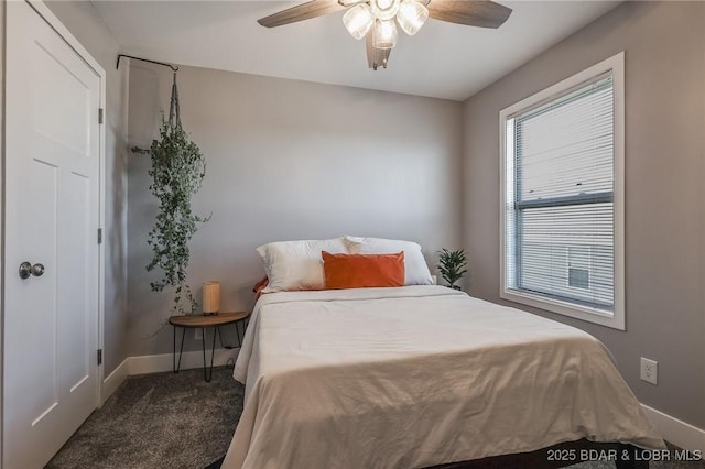 bedroom with a ceiling fan, carpet flooring, and baseboards