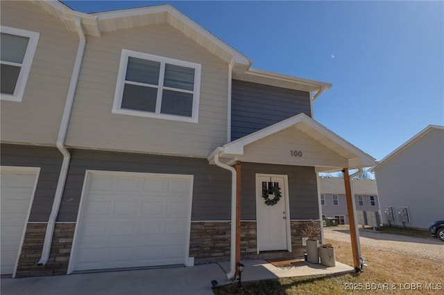 view of front of property with stone siding and an attached garage