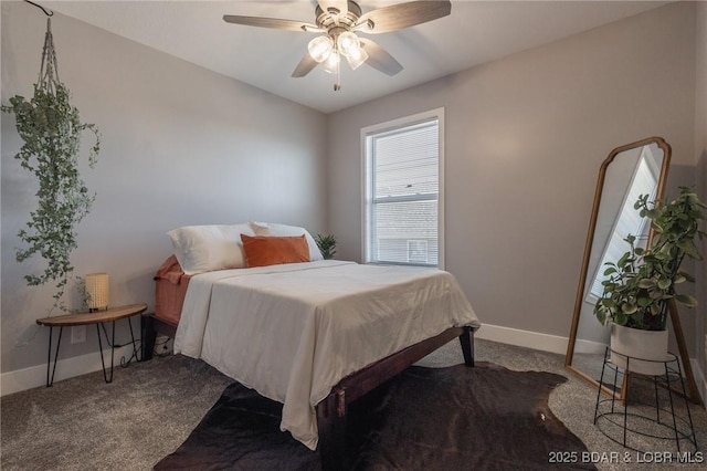 carpeted bedroom with ceiling fan and baseboards