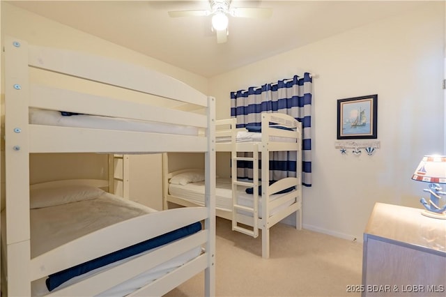 carpeted bedroom featuring ceiling fan and baseboards