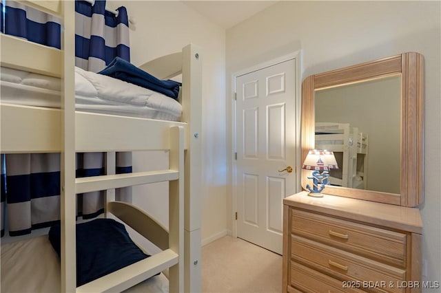 bedroom featuring light carpet