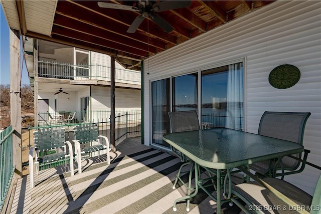 wooden deck with ceiling fan and outdoor dining area