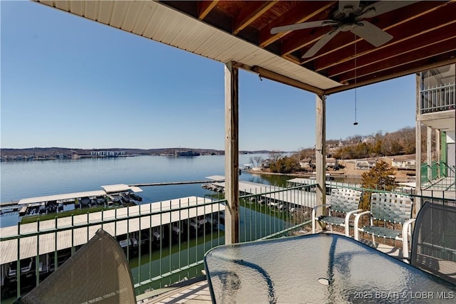 balcony featuring a water view and a ceiling fan