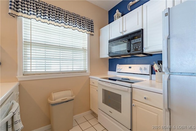 kitchen with white appliances, light tile patterned floors, baseboards, light countertops, and white cabinetry