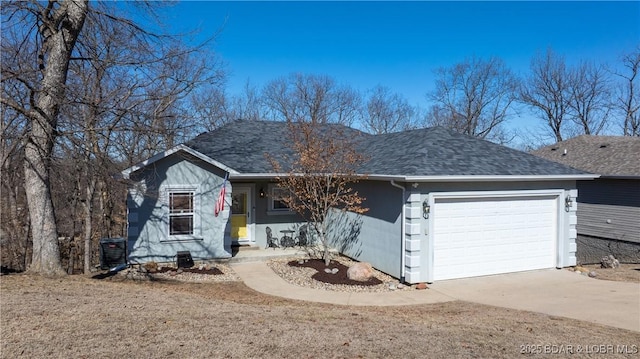 single story home featuring driveway, roof with shingles, an attached garage, and cooling unit