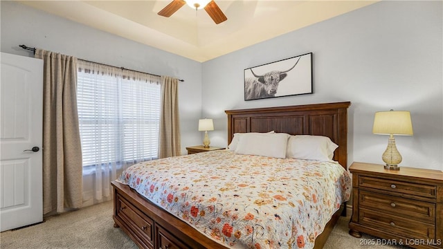 bedroom with ceiling fan and light colored carpet