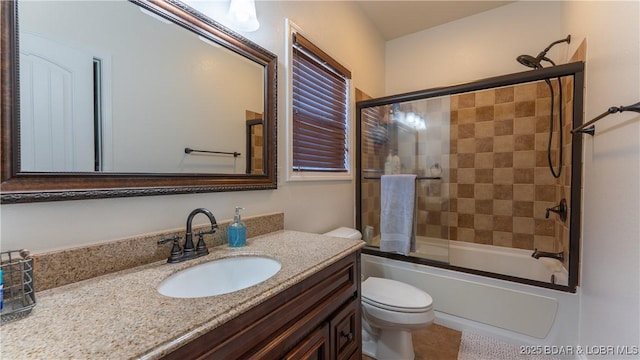 bathroom with bath / shower combo with glass door, toilet, tile patterned flooring, and vanity