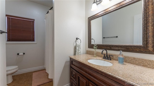 full bath with baseboards, vanity, and toilet