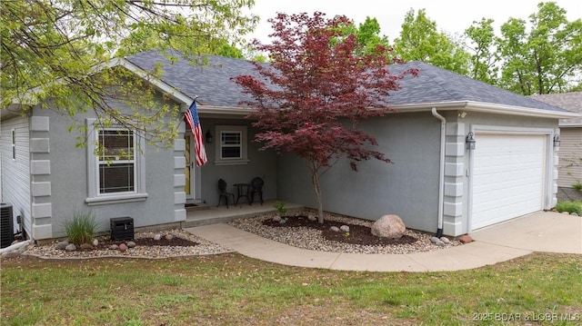 exterior space featuring roof with shingles and an attached garage