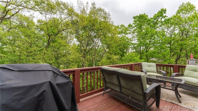 wooden deck with an outdoor living space and grilling area