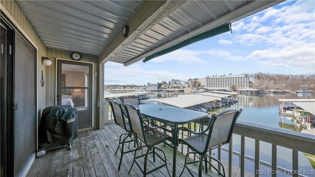 balcony featuring a water view, a grill, and a view of city