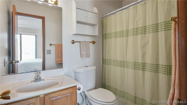 bathroom featuring toilet, vanity, and ensuite bathroom