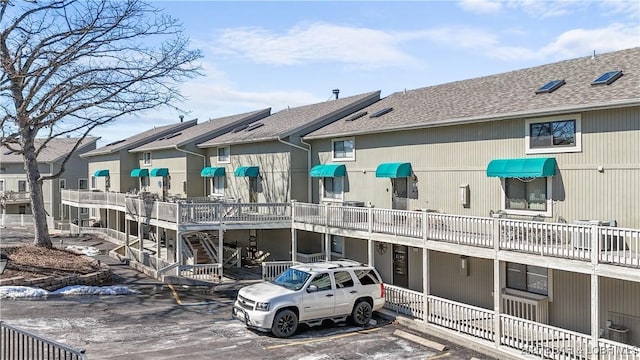 view of property featuring uncovered parking and a residential view