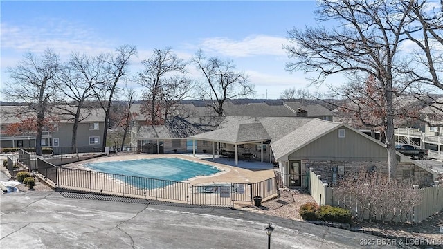 pool with a patio area and fence private yard