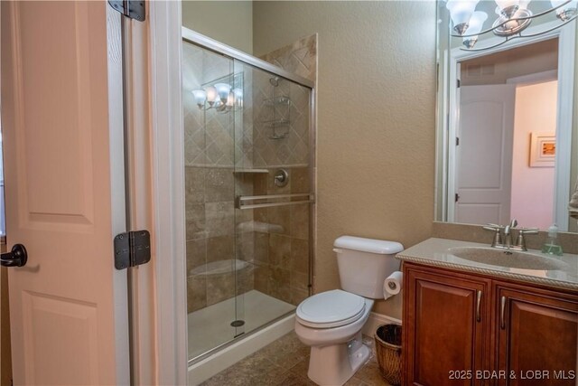 1184 Jeffries Rd Unit 416, Osage Beach, MO 65065 - full bathroom with vanity, a shower stall, toilet, and an inviting chandelier