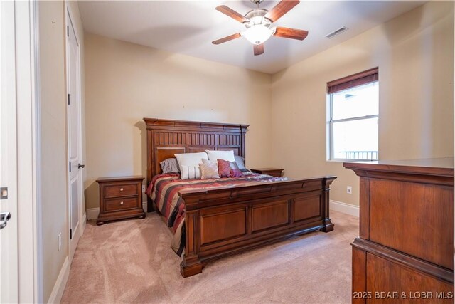 1184 Jeffries Rd Unit 416, Osage Beach, MO 65065 - bedroom with light carpet, ceiling fan, visible vents, and baseboards