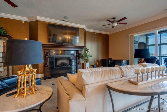 1184 Jeffries Rd Unit 416, Osage Beach, MO 65065 - living area with ceiling fan, ornamental molding, a tile fireplace, and tile patterned flooring