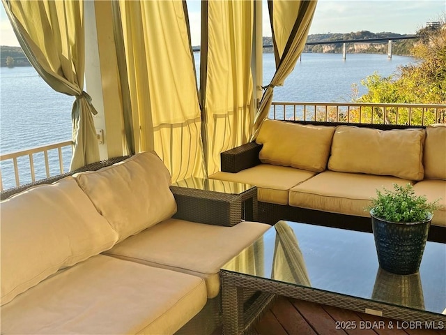 balcony featuring a water view and outdoor lounge area