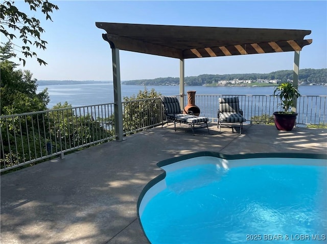 view of pool with a water view, fence, a fenced in pool, and a patio