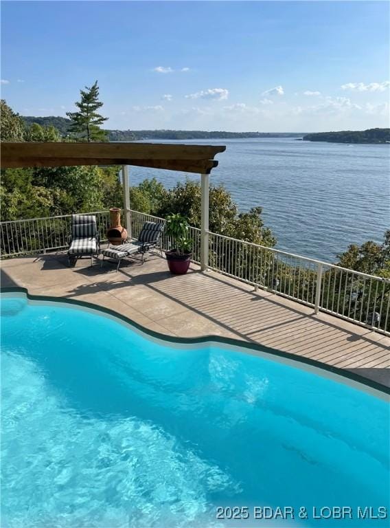 outdoor pool featuring a water view