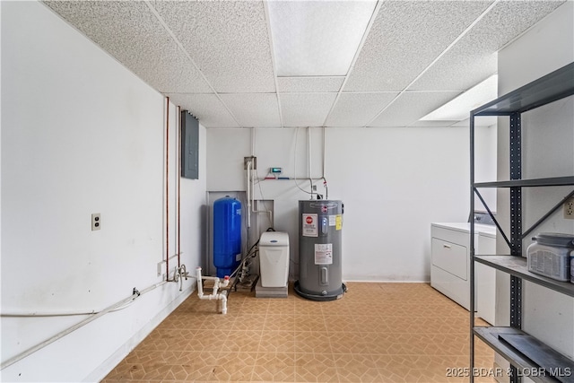 finished basement with light floors, a paneled ceiling, washer / clothes dryer, electric water heater, and electric panel