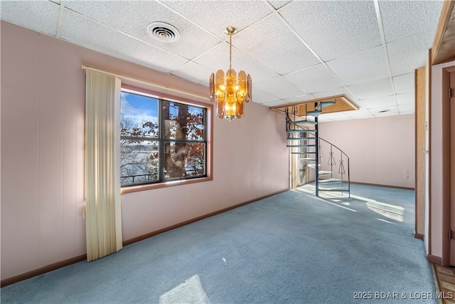 interior space featuring a paneled ceiling, carpet, stairs, and visible vents