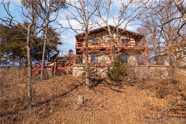 back of property featuring a deck