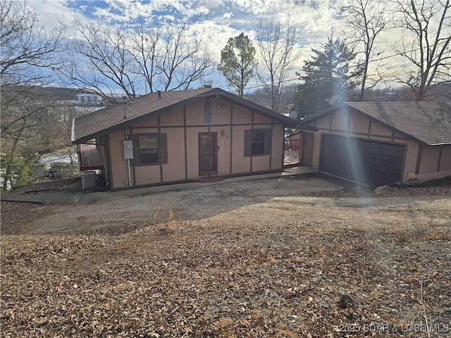 exterior space with central AC and a shingled roof