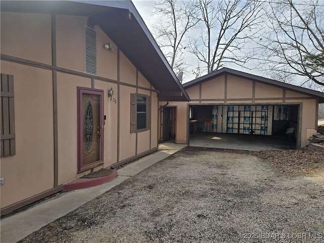 view of property exterior featuring an outdoor structure and stucco siding