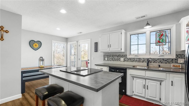 5317 Locust Ct, Osage Beach, MO 65065 - kitchen featuring a sink, black appliances, dark countertops, a textured ceiling, and tasteful backsplash