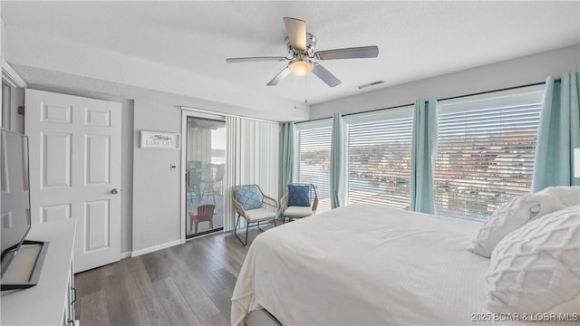 bedroom with access to exterior, visible vents, ceiling fan, wood finished floors, and baseboards