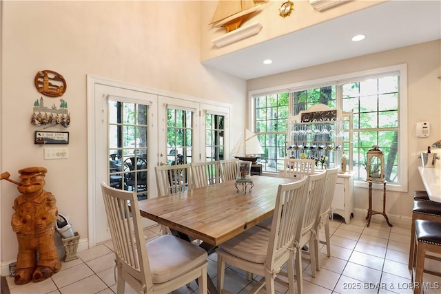 dining space with light tile patterned floors, baseboards, french doors, and recessed lighting