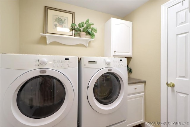 laundry area featuring cabinet space and washer and clothes dryer