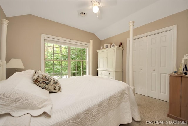 bedroom featuring decorative columns, visible vents, a ceiling fan, vaulted ceiling, and a closet