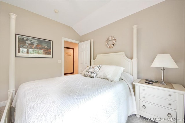 carpeted bedroom featuring lofted ceiling