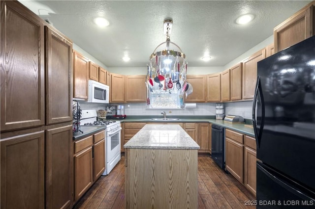 kitchen featuring dark wood-type flooring, a center island, backsplash, and black appliances