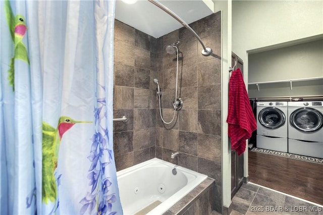 bathroom with a combined bath / shower with jetted tub and washing machine and clothes dryer