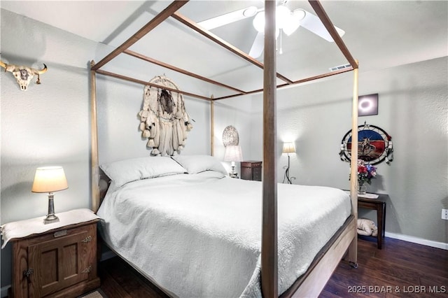 bedroom with baseboards and wood finished floors