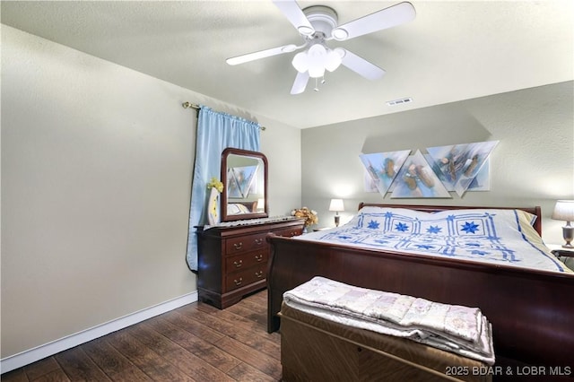 bedroom with baseboards, visible vents, dark wood finished floors, ceiling fan, and a textured ceiling