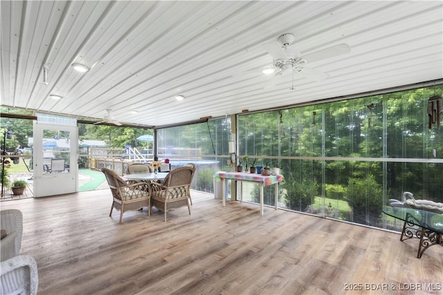 sunroom / solarium with a ceiling fan