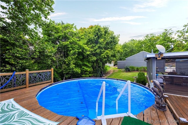 view of swimming pool with a wooden deck