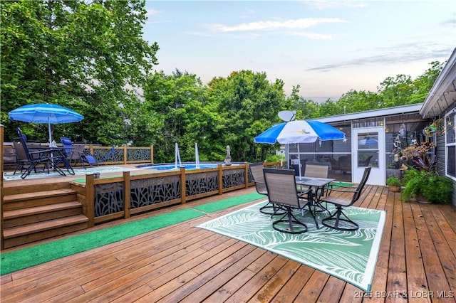 deck featuring an outdoor pool and outdoor dining area