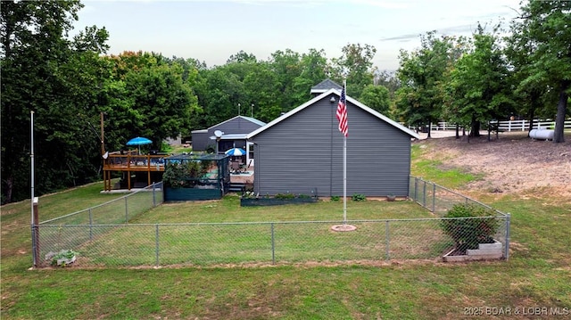 exterior space featuring a yard, a deck, and fence